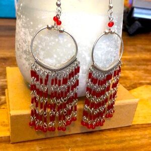 Red long dangling cascade earrings. Glass beads on silver tone metal